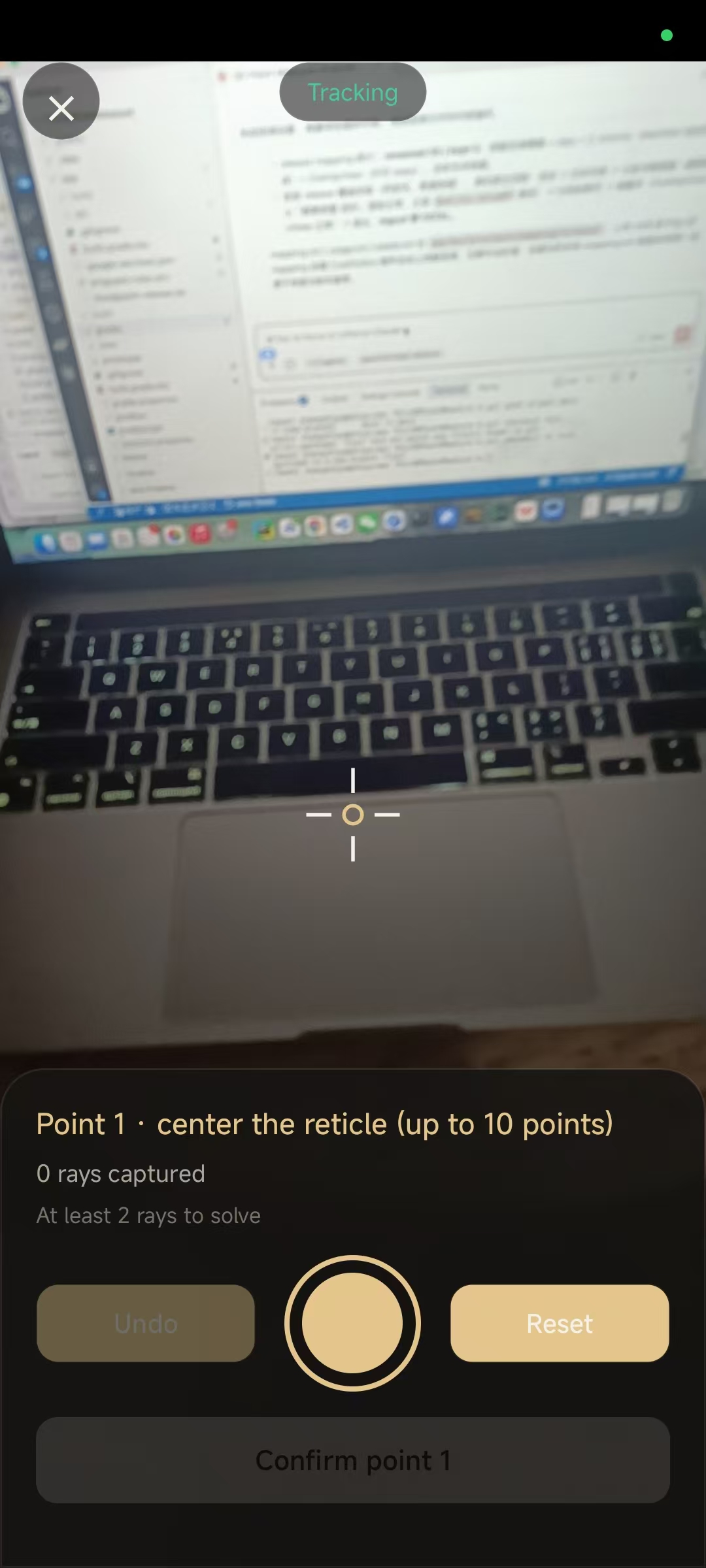 Camera measurement view with reticle centered on a laptop keyboard, panel asking to capture rays for point 1